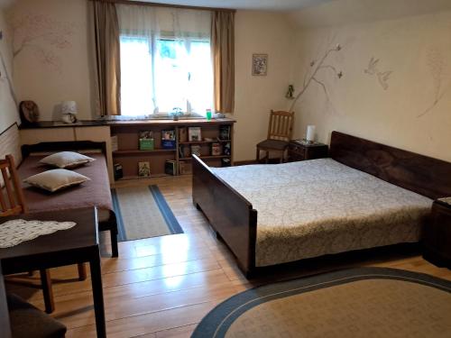 a bedroom with a bed and a table and chairs at Art & Sun in Kočevje