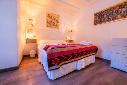 a bedroom with a bed and a dresser at Hostal Copart in San Pedro de Atacama