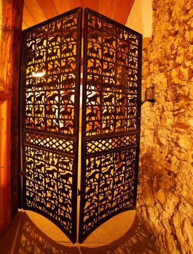 an ornate metal door in a stone wall at Living History (adults only) in Hallstatt