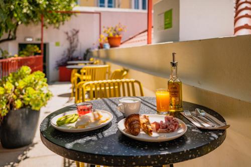 a table with two plates of food on it at Casa do Bairro by Shiadu in Lisbon