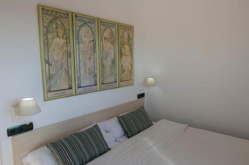 a bedroom with a bed and a painting on the wall at 2 bedroom apartment close to the center of Begur. Terrace and panoramic sea views (Ref:H41) in Begur