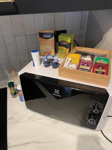 a microwave with a box on top of it at Central apartment in Ålesund