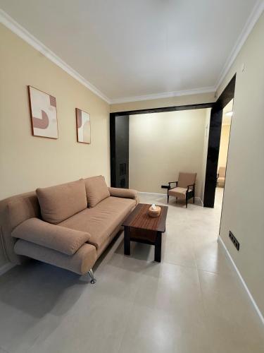 a living room with a couch and a coffee table at DendroBak GuestHouse in Stepʼanavan
