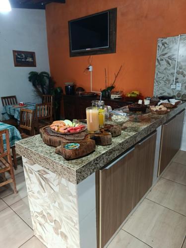 a table with food and drinks on top of it at POUSADA MANACÁ DA SERRA in Vargem Bonita