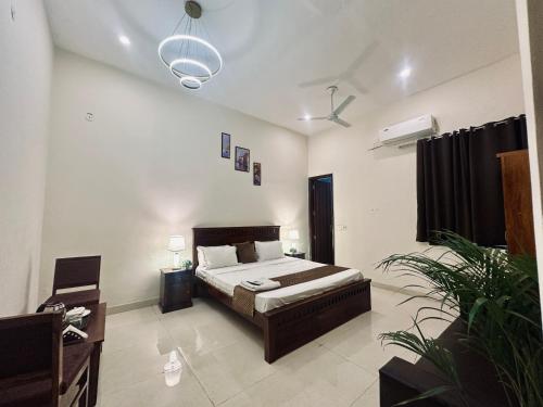 a bedroom with a bed in a room at The White Scent-Near Noida Sector34 Metro in Noida