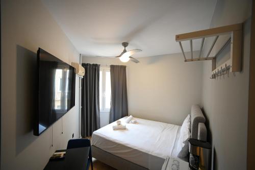 a bedroom with a white bed and a window at Family Suite by Zeussuites in Athens