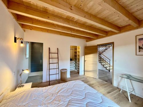 a bedroom with a bed and a wooden ceiling at Chalet 5 pièces, garage, terrasse, 8 pers - FR-1-608-263 in Le Mont-Dore