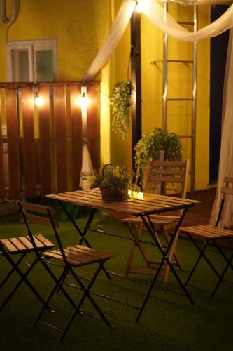 a patio with a table and chairs and lights at D A L Premium Capsule Hotel in Seoul