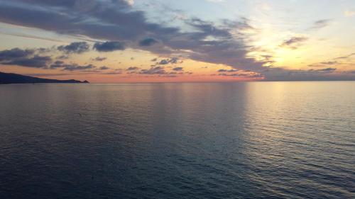 a sunset over a large body of water at Sicily Sea House in Gioiosa Marea