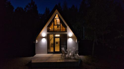 a small house with a pitched roof at night at Wild Beauty Brezna in Pluzine