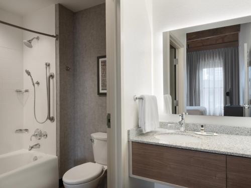 a bathroom with a sink and a toilet and a mirror at Residence Inn by Marriott Boston Downtown Seaport in Boston