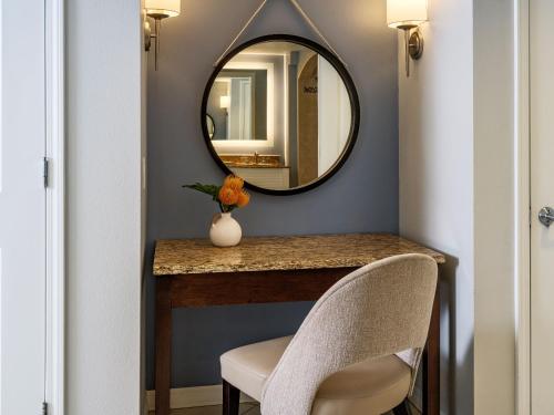a hallway with a mirror and a table and chairs at Hyatt Regency Clearwater Beach Resort & Spa in Clearwater Beach