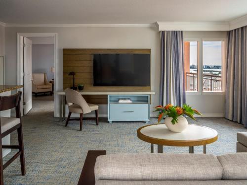a living room with a couch and a television at Hyatt Regency Clearwater Beach Resort & Spa in Clearwater Beach