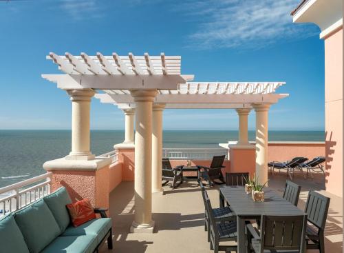 a balcony with a table and chairs and the ocean at Hyatt Regency Clearwater Beach Resort & Spa in Clearwater Beach