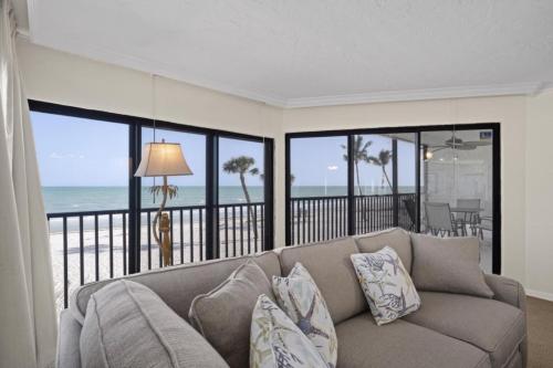 a living room with a couch and a view of the ocean at Pointe Santo A24 condo in Sanibel