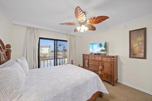 a bedroom with a bed and a ceiling fan at Pointe Santo A24 condo in Sanibel