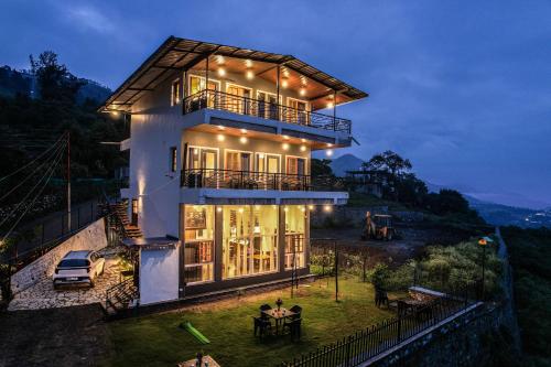a house with a table in front of it at night at Celeste Vista by Chirping Hills in Bhīm Tāl