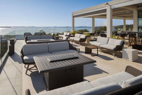 a patio with couches and a table and chairs at Grotto Bay Beach Resort in Tuckerʼs Town