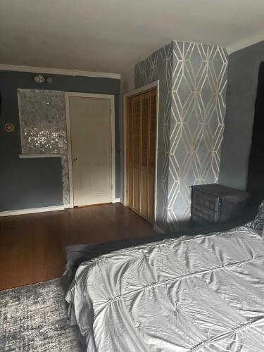 an empty bedroom with a bed and a door at Your Home away from Home ! UNIT 2- 1st floor in Baychester