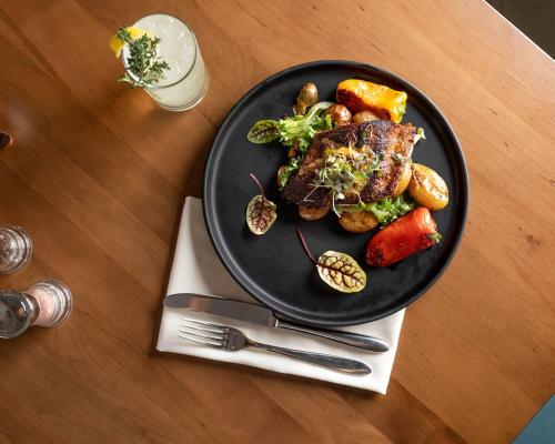 a plate of food with meat and vegetables on a table at Hyatt Regency Clearwater Beach Resort & Spa in Clearwater Beach
