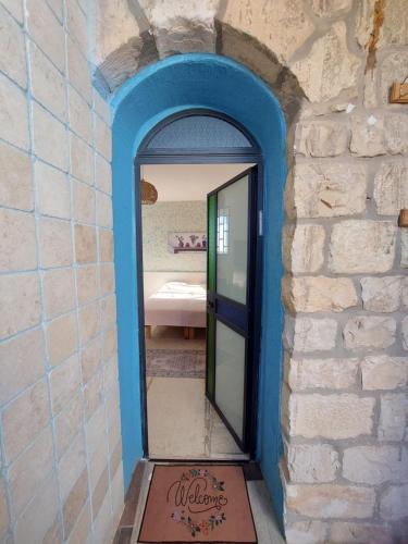 a doorway into a room with a mirror in a wall at The Essence Tzimer in Safed