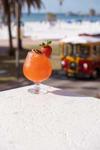 a drink sitting on a ledge with a strawberry in it at Hyatt Regency Clearwater Beach Resort & Spa in Clearwater Beach