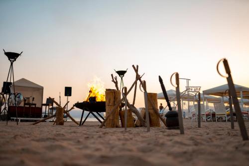 a beach with a bonfire in the sand at InterContinental Aqaba by IHG in Aqaba