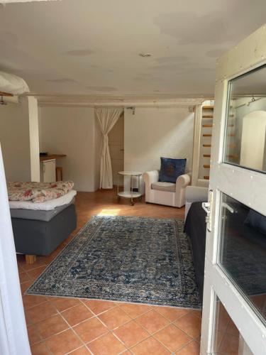 a living room with a bed and a couch at Huset på hörnet in Hammenhög