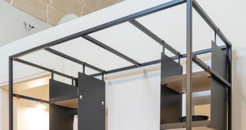 a glass and steel staircase in a house at Josef Room b&b in Pulsano