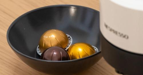 three eggs in a black bowl next to a cup at Josef Room b&b in Pulsano