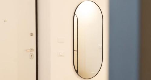 a mirror hanging on a door at Josef Room b&b in Pulsano