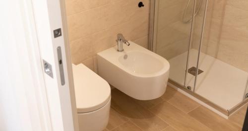 a bathroom with a sink and a toilet and a shower at Josef Room b&b in Pulsano