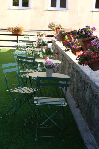 a group of tables and chairs with potted plants at Pollino Flower Park in Viggianello