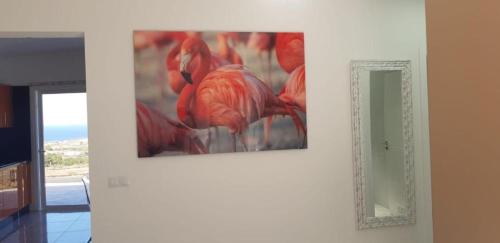 a painting hanging on a wall next to a mirror at Casa Miramar in Frontera
