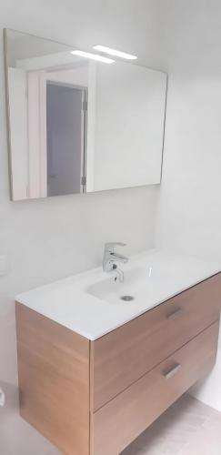 a bathroom sink with a large mirror above it at Casa Miramar in Frontera