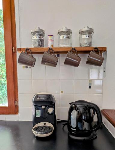 a toaster sitting on a counter in a kitchen at Gîte Belle, Piscine privée, vue sur la campagne in Nonac