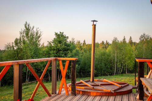 a wooden bridge with a light on top of it at Cabana Foxes' Shelter din Beliș, Apuseni in Călăţele
