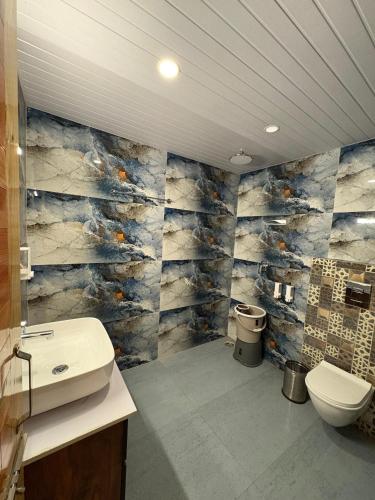 a bathroom with a sink and a toilet at Hide-In Kasol in Kasol