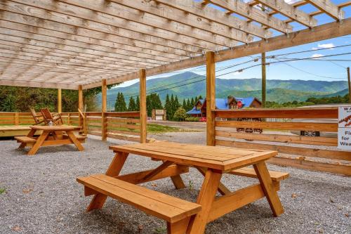 a group of picnic tables sitting under a wooden structure at Wild Mountain Lodge in Sevierville