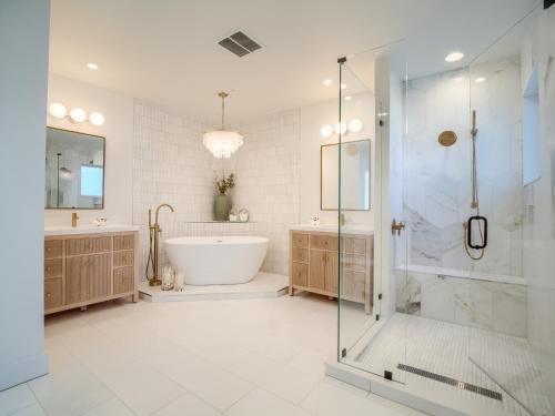a bathroom with a tub and a glass shower at Sandrift Villa in Captiva