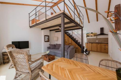 a living room with a table and chairs and a staircase at Apartments Argemonia in Mali Lošinj