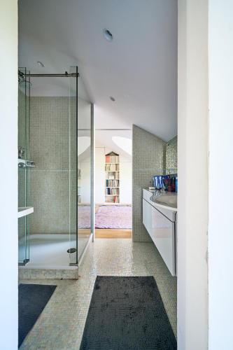 a bathroom with a shower with a glass door at La Petite Bruyere De Renaix in Ronse