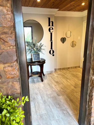 a hallway with a table and a mirror in a room at Casa Madeira 1 in Gillitts