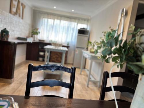 a kitchen and dining room with a table and chairs at Casa Madeira 1 in Gillitts