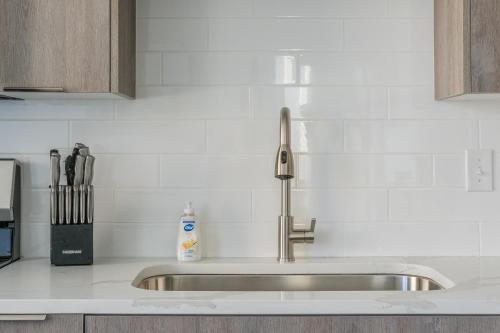 a kitchen sink with a faucet on a counter at Landing at The 600 - Birmingham in Birmingham
