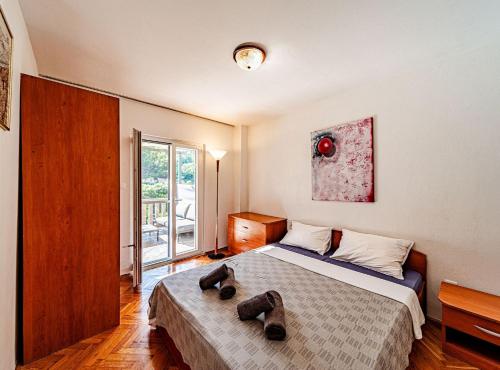 a bedroom with a bed with two teddy bears on it at Holiday Home Island Gem in Korčula