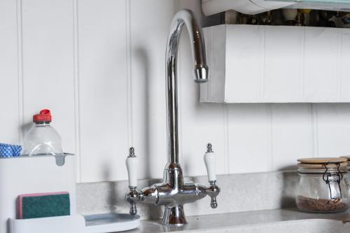 a kitchen sink with a faucet on a counter at Hot Tub Luxury Glamping - Private Stargazing Patio in Yarpole