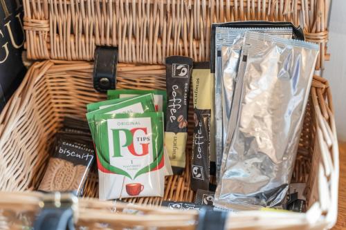 a basket with food and other items in it at Hot Tub Luxury Glamping - Private Stargazing Patio in Yarpole