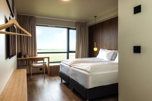 a hotel room with a bed and a window at Hotel Loa in Hvolsvöllur