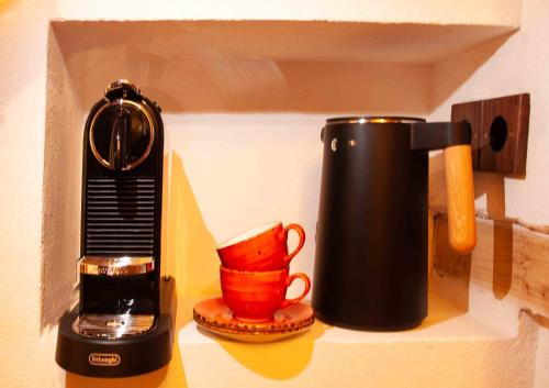 a coffee maker and a mug on a shelf at Living History (adults only) in Hallstatt